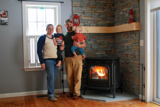 Harman Hero winner stands with his family next to his new hearth