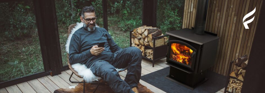 A man settles in a cabin with a wood stove and his pet dog