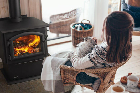 A woman enjoys sitting in front of her stove