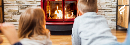 an image of two children lounging next to a Vermont Castings Stardance gas stove