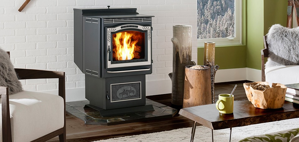 A pellet stove radiating warmth sits in a cozy living room with rustic decor and a snowy mountain view.
