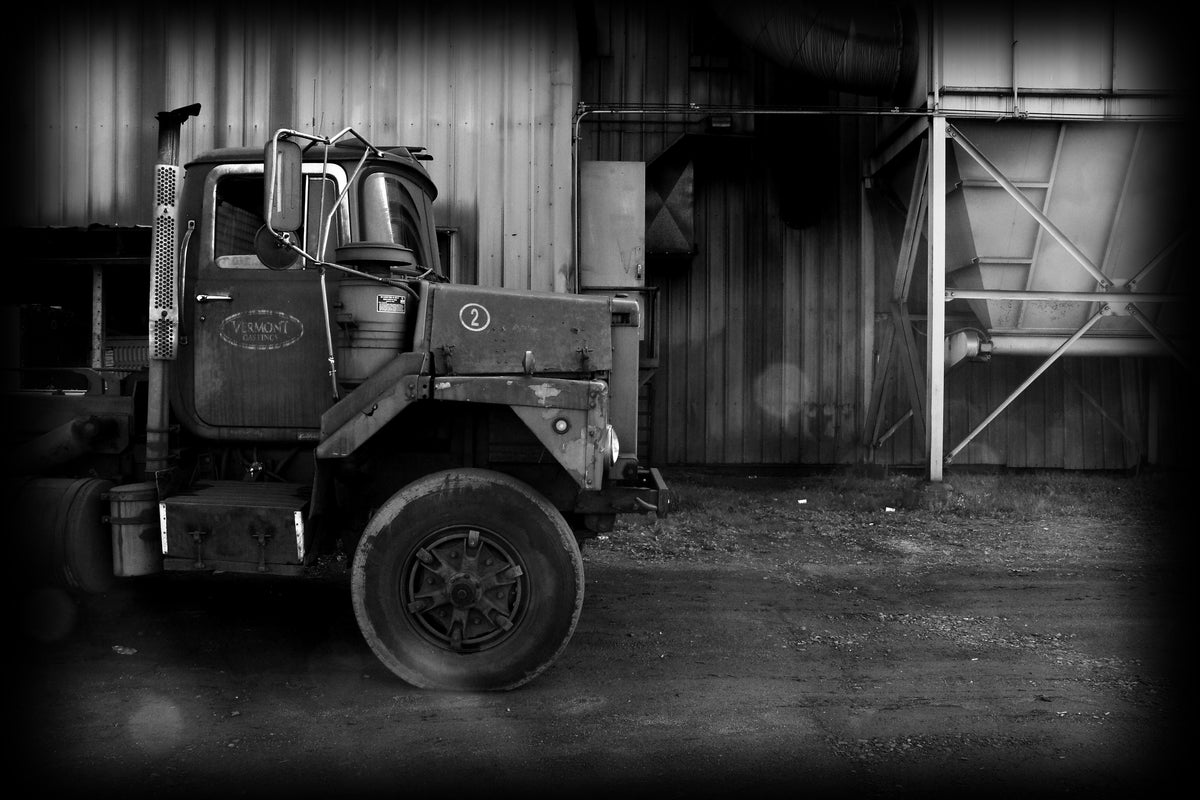 black and white photo of an old truck with an old vermont castings logo on the truck door